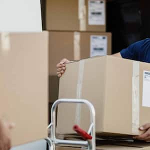Worker unloading cardboard boxes