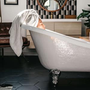 woman taking a bath in claw foot tub