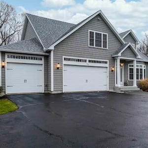 gray suburban house with asphalt driveway 