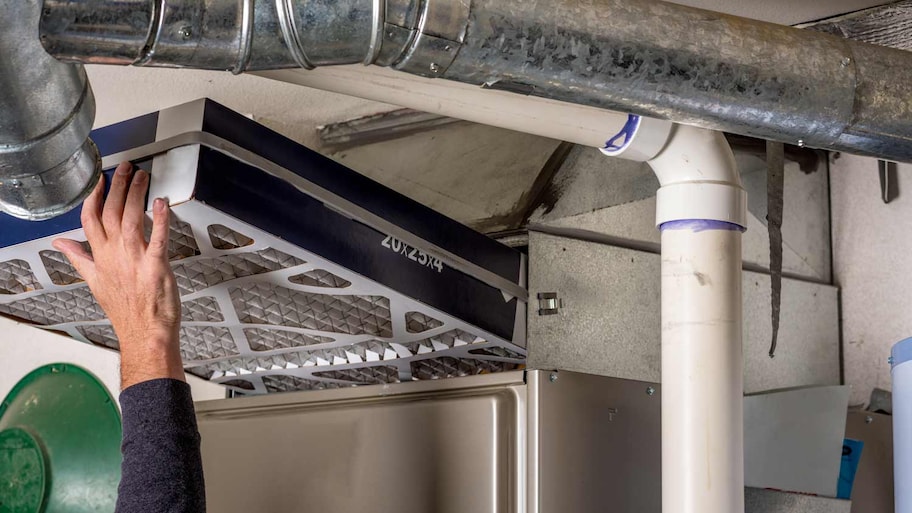 man inspecting furnace for asbestos