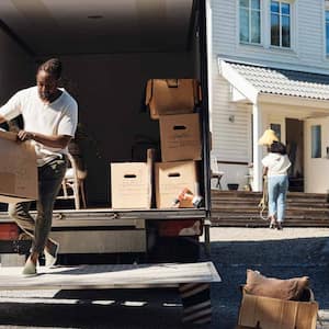 Man unloading cardboard box from van