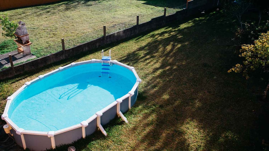 An above ground pool in a backyard