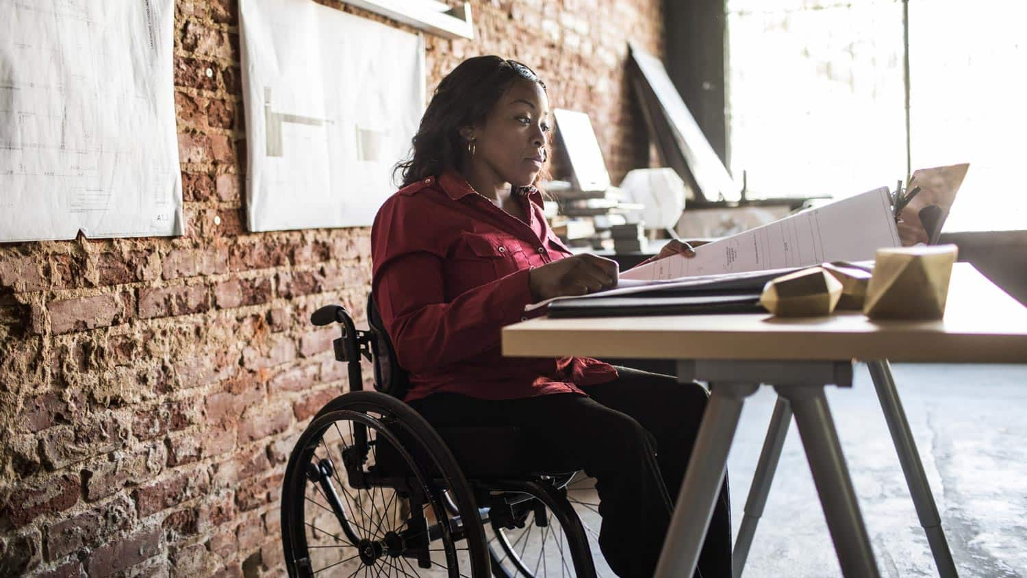 A woman in sitting behind a desk