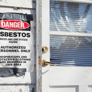 danger asbestos sign posted on house