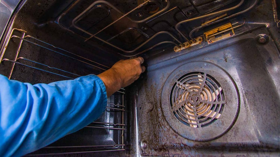 man fixing baking element 