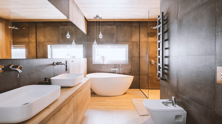 Modern bathroom with concrete backsplash, white vessel sink, and wooden accent wall