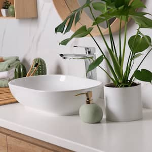 Modern bathroom with a marble backsplash, wooden vanity, and white vessel sink