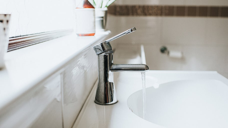 A bathroom faucet running water