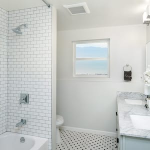 Renovated bathroom with white tile