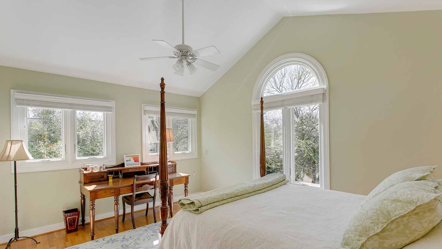 A beautiful bright bedroom with a vaulted ceiling