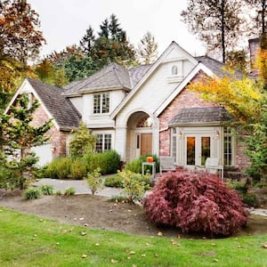 A beautiful house with bushes in its front yard