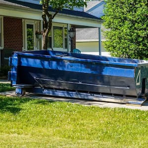 Blue dumpster in the driveway