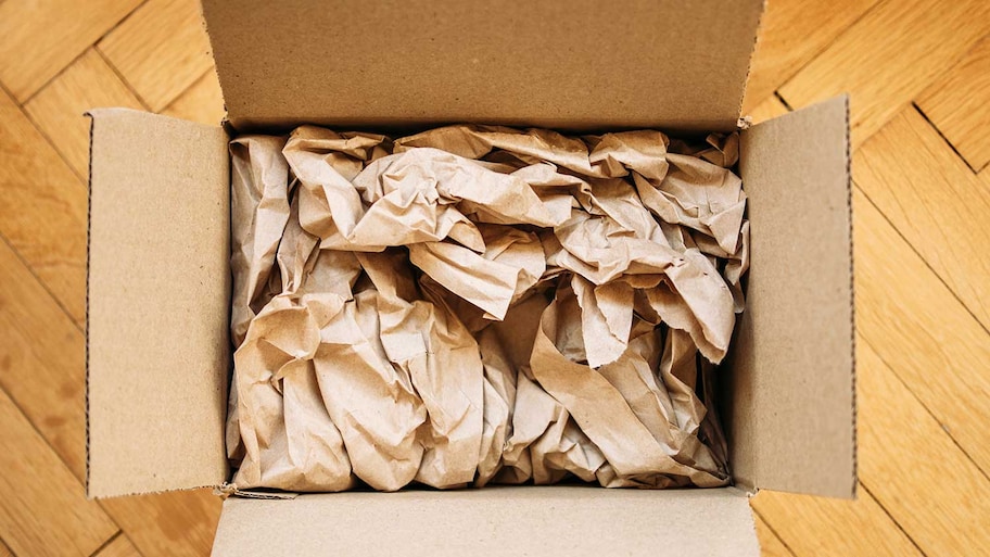 Cardboard box filled with packing paper