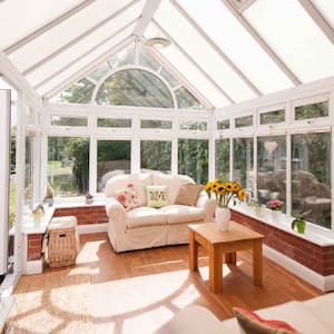  A sunroom with two sofas on a bright day