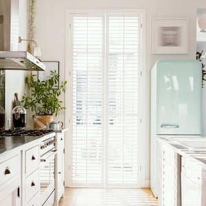 A bright white kitchen with a pastel fridge