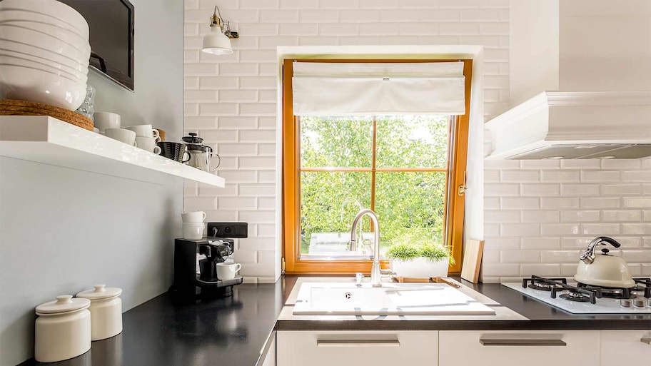 white kitchen with black countertop 