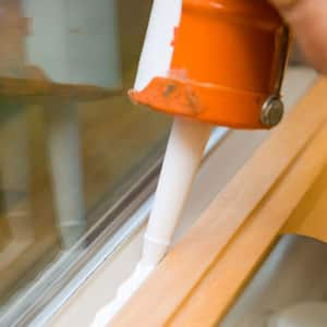 Close-up of caulking a window