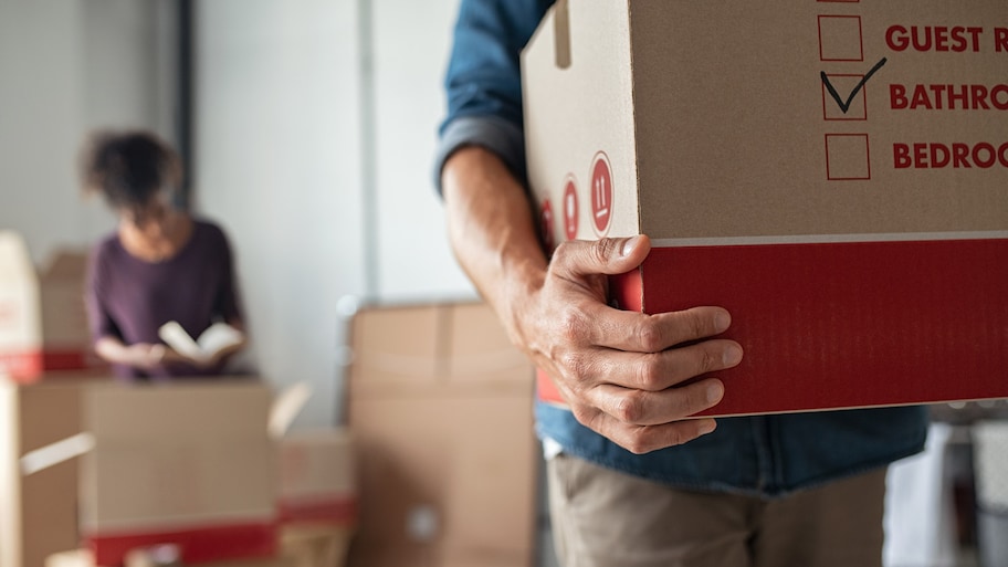 A close-up of a professional caring a box