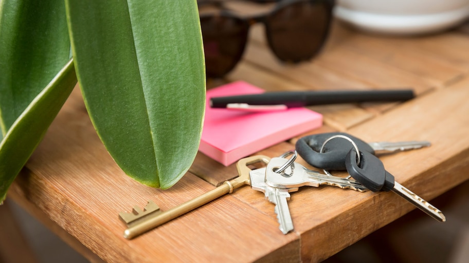 Close-up of keys left on a wooden table