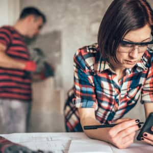 Female construction manager one smartphone