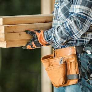 man carrying pieces of wood 