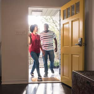 A couple arriving at their house