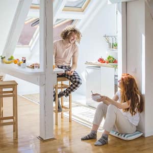 Couple in an attic apartment having breakfast