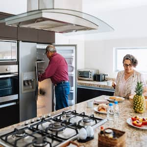 Senior couple in the kitchen making breakfast