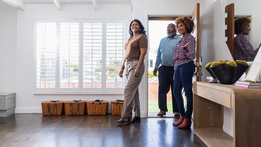 Female real estate agent showing home to mature couple