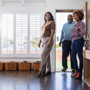 Female real estate agent showing home to mature couple