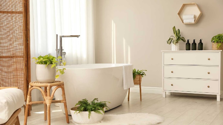 A cozy bathroom with a white bathtub