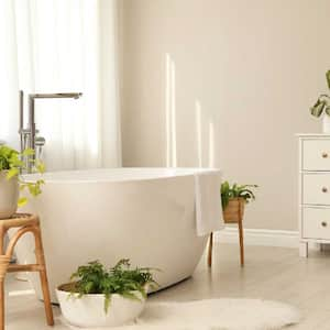 A cozy bathroom with a white bathtub