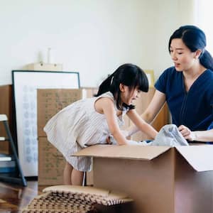 Daughter helping her mother to pack