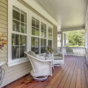 a deck features patio furniture, wood floor, and four large windows