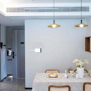 A dining area with an air vent above the table