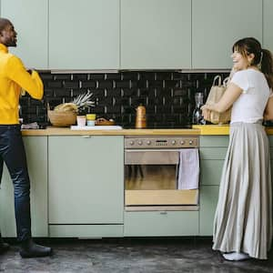 Happy couple doing chores in the kitchen