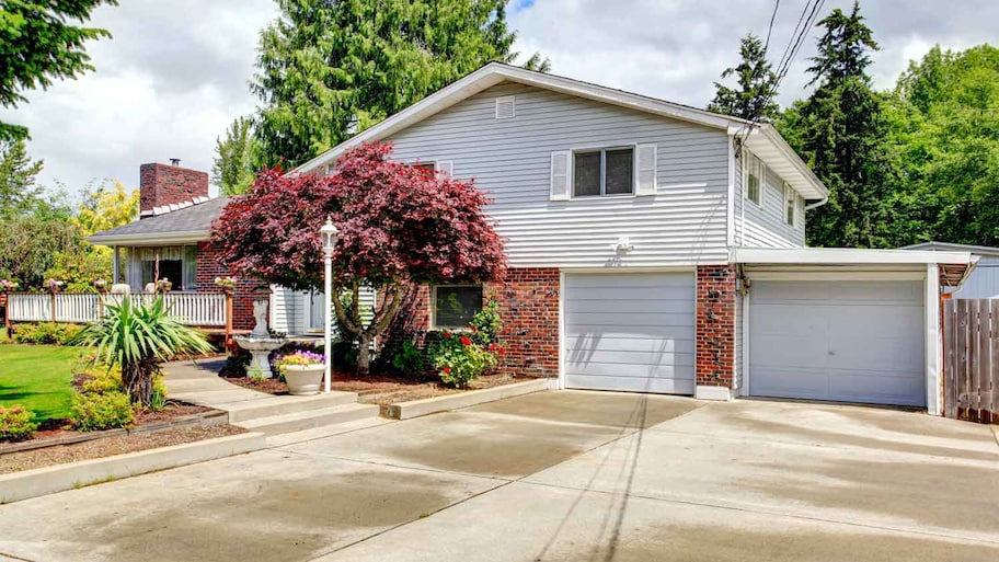 The exterior of a house with a white garage 