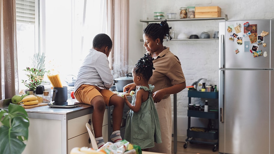 A family cooks together in a kitchen