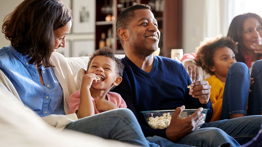 A family eats popcorn