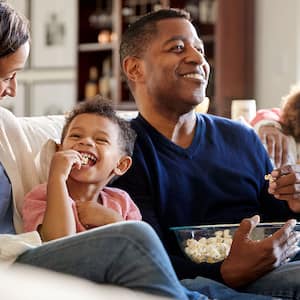 A family eats popcorn