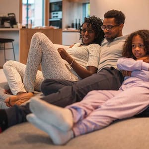 A family of three enjoying a night at home