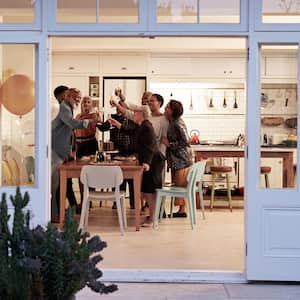 A family toasting at a birthday dinner in an open-plan kitchen