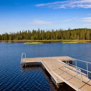 A floating dock overlooking a lake and trees