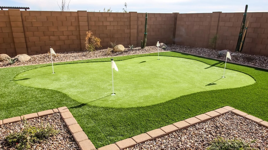 A four hole putting green in a house’s backyard