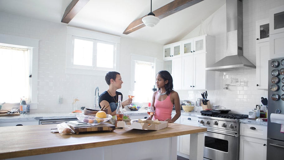 Friends eat in updated kitchen