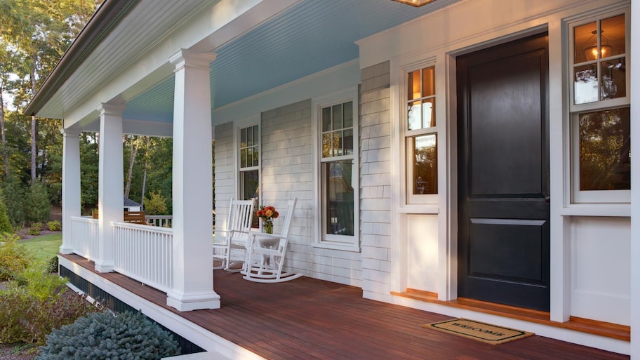 The front porch of a house with two rocking chairs