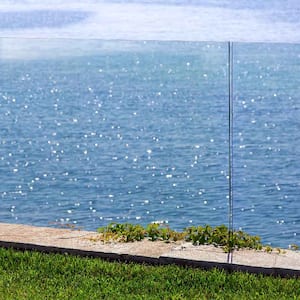 A garden with a glass fence and magnificent seaview