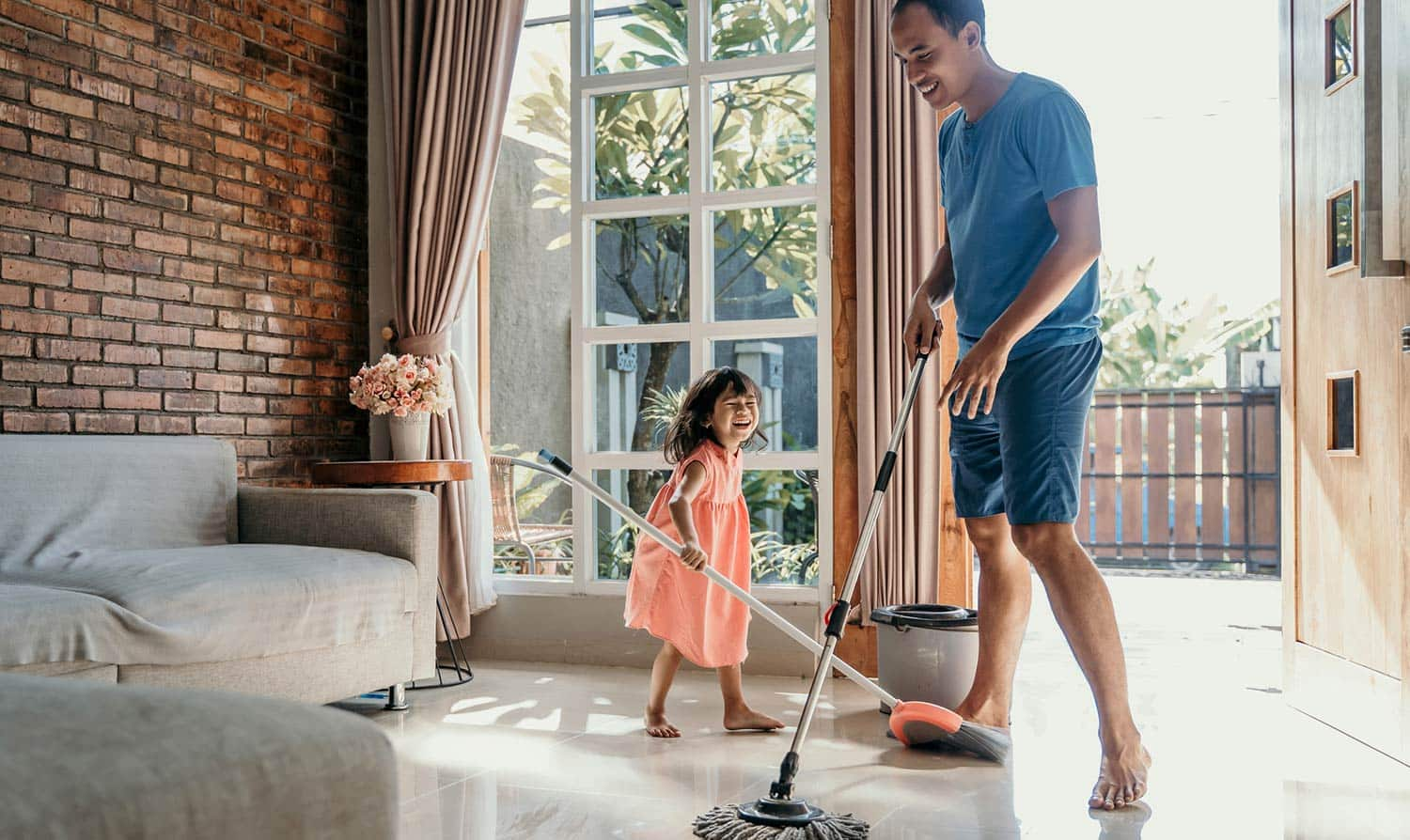 Girl doing chores with dad