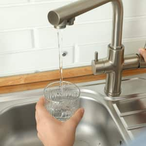 woman getting a glass of tap water