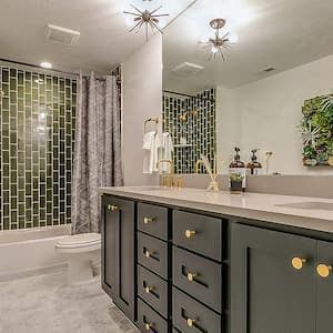 Green tile in bathroom with green cabinets